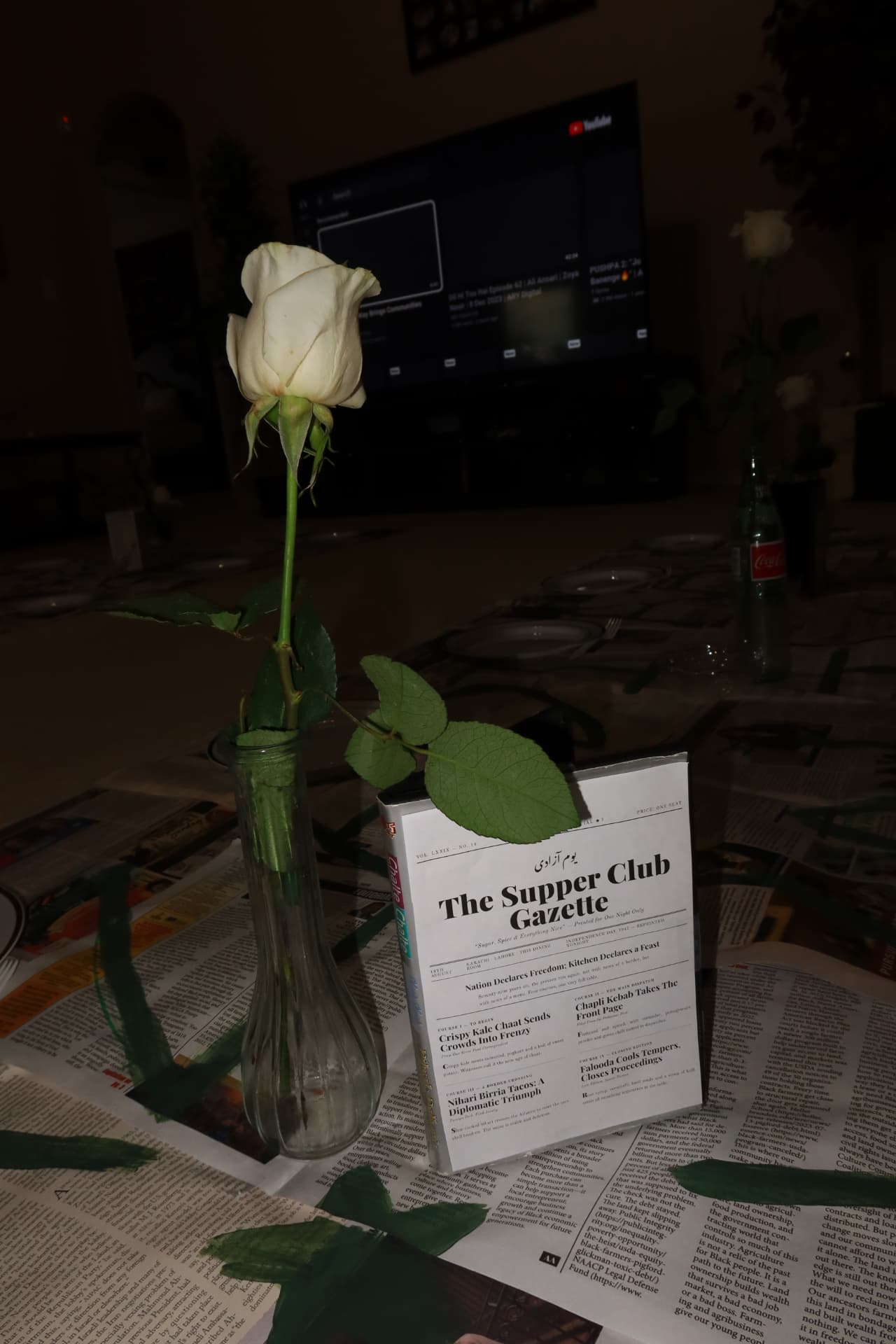 A single white rose on the Supper Club Gazette table