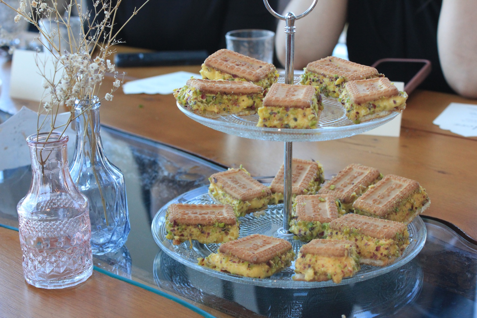 Pistachio desserts presented on a glass stand