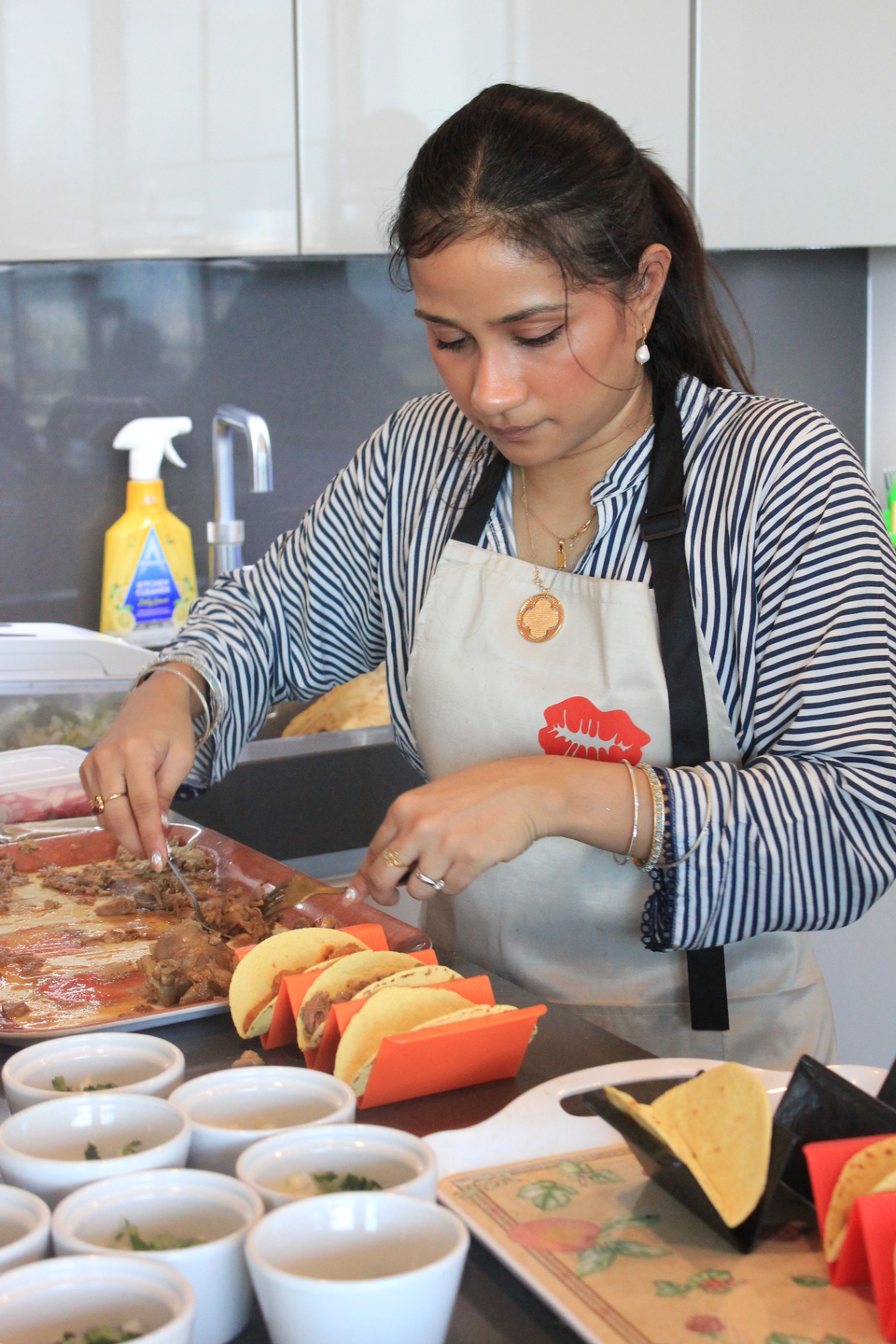 Tacos being plated in the kitchen before service
