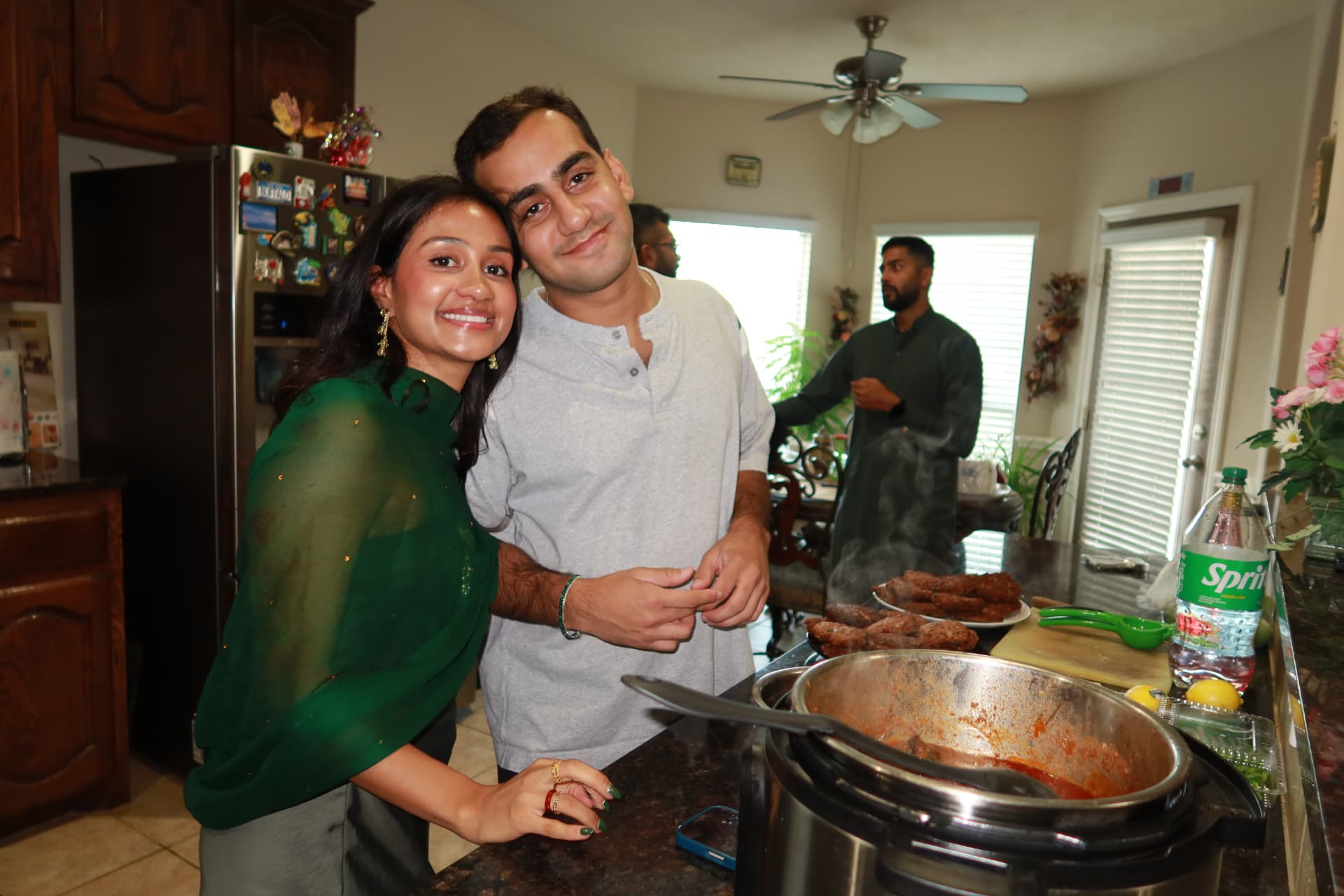 The hosts together in the kitchen