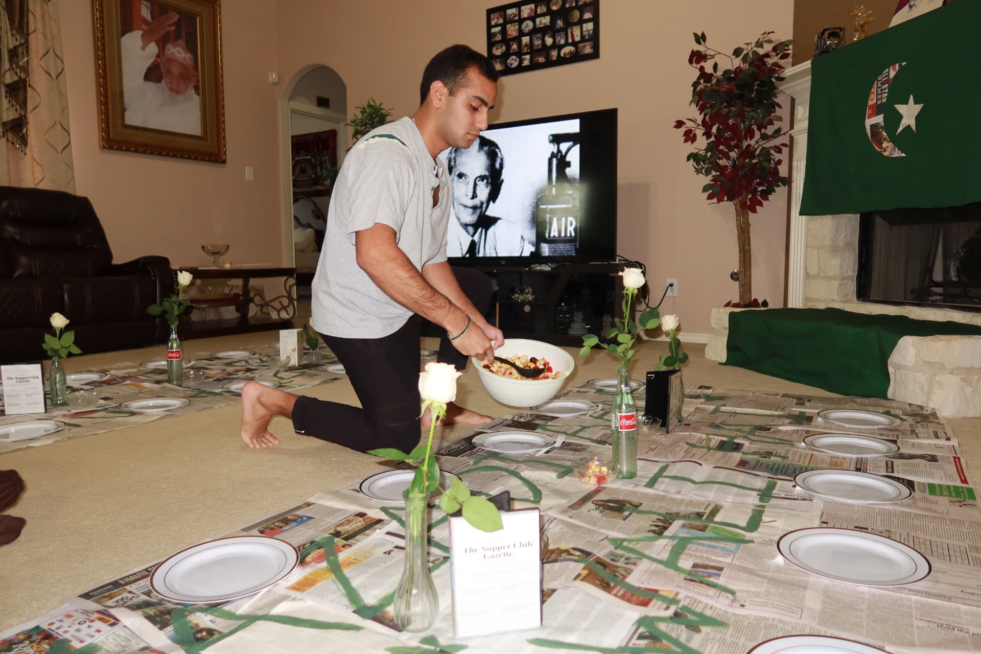 Setting the newspaper-covered table with roses and gazette menus