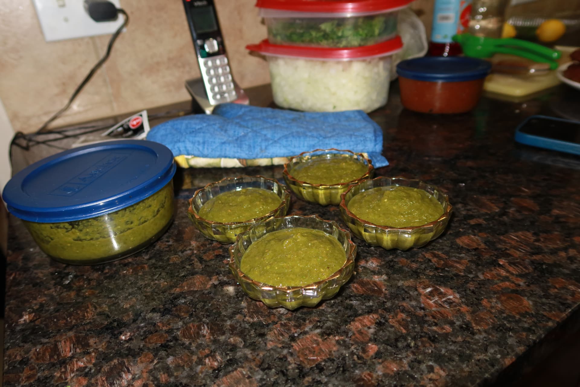 Bowls of homemade green chutney in the kitchen