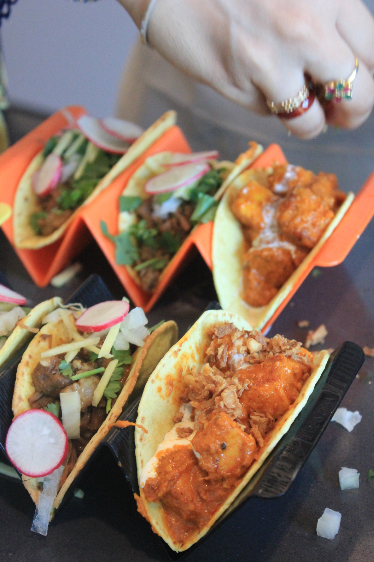 Tacos topped with radish and herbs